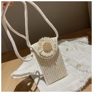 Detail of hand-woven crossbody bag with a 3D daisy flower and thick cotton rope strap