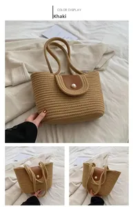 Detail of khaki woven beach bag featuring a brown leather flap and large pearl closure