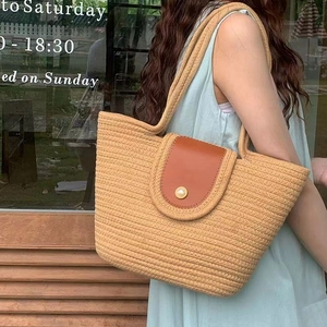Handmade straw tote bag with brown leather flap and pearl buckle for summer beach trips