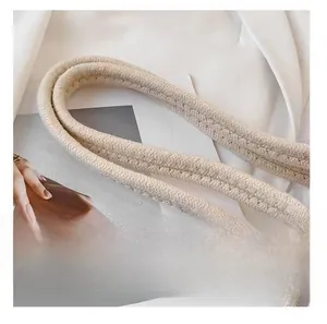Detailed view of durable thick woven cotton rope handles on a beige summer beach tote bag