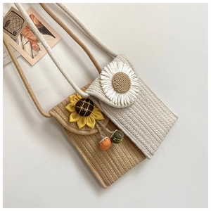 Detail of hand-woven cotton rope phone bags with daisy and sunflower floral accents