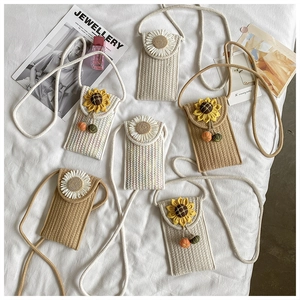 Detailed view of woven phone bags with knitted sunflower and daisy floral accents