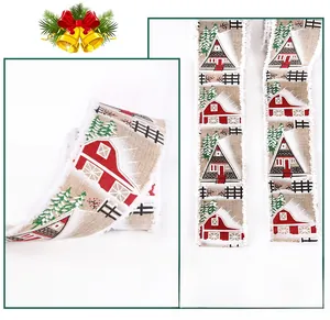 Detailed macro view of khaki burlap Christmas ribbon with snowy house and pine tree prints