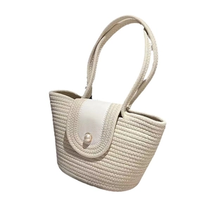 Handwoven cream cotton rope beach tote bag with a white leather flap and large pearl buckle