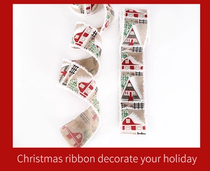 Detail of Christmas burlap ribbon with red barn, green tree prints and white frayed edges