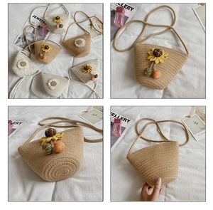 Detailed close-up of handmade straw bucket bag with 3D sunflower and daisy floral accents