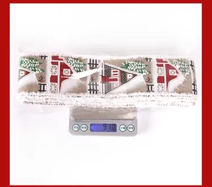 5m rustic Christmas ribbon roll with snow house prints weighing 91g on a scale