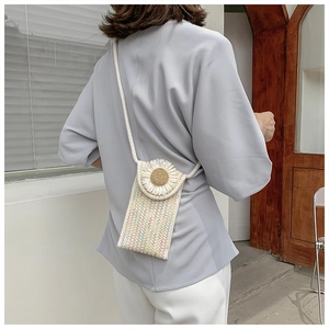 Detailed knit shoulder bag showing white daisy pattern and colorful wavy texture