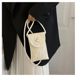 Close-up of woven mini phone bag with colorful zigzag texture and large pearl button