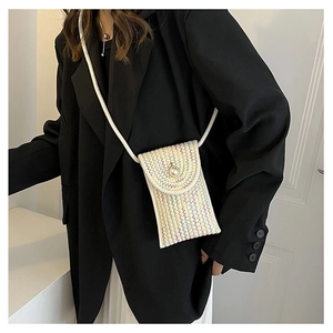 Detail of hand-woven mini crossbody bag with colorful waves and pearl button closure