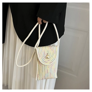 Detail of colorful woven mini crossbody bag with a large pearl buckle and white rope strap