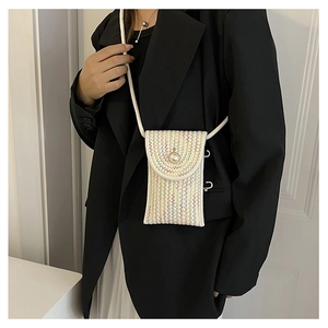 Straw woven mini phone bag featuring colorful wave patterns and a large pearl buckle detail