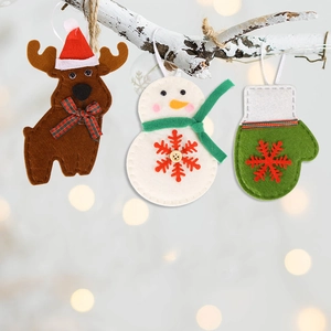 Felt Christmas ornaments set with reindeer and snowman hanging on a snowy branch