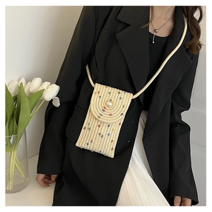Detail of straw mini crossbody phone bag with colorful dots and pearl buckle decoration