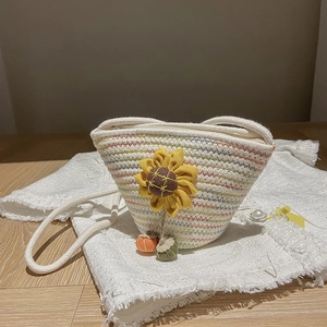 Detailed close-up of woven cotton rope bucket bag with sunflower and rainbow accents