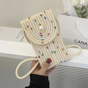 Mini straw woven phone bag with colorful dots and a decorative pearl button closure