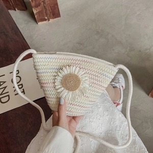 Floral woven triangle bucket bag with daisy detail and rope strap for beach vacations