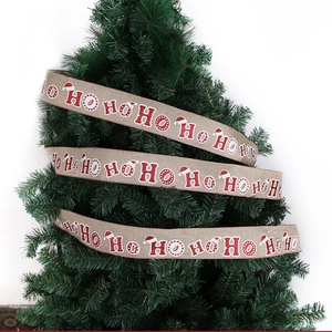 Detail of 2m burlap Christmas ribbon with red glitter HO HO HO print on Xmas tree