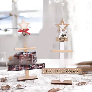 Detail of wooden DIY Christmas tree tabletop ornaments with bows and metal bells