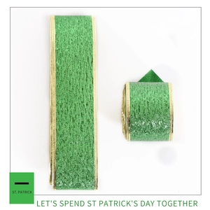 Detailed view of green St. Patrick's Day ribbon with metallic texture and gold edge finish