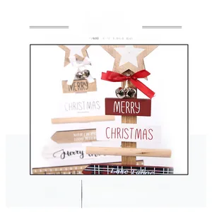 Detail of wooden Christmas tree decor with white star, bow, bell and festive lettering