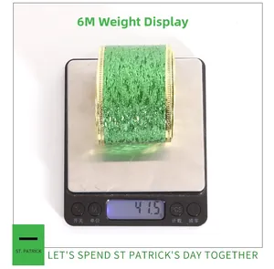 Detailed view of 6-meter green glitter ribbon with gold edges on an electronic scale