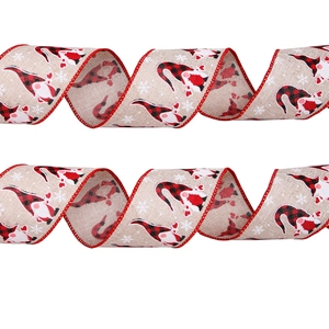 Close-up of linen-style Christmas ribbon with gnome patterns and red wired edges for DIY