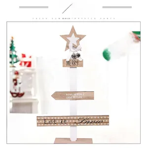 Close-up of DIY wooden Christmas tree tabletop ornament with metal bell and ribbon