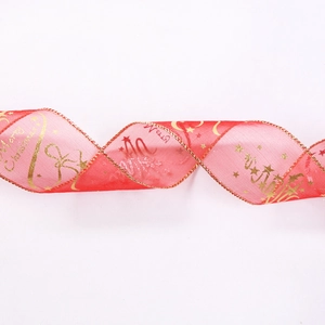 Detail of red sheer Christmas ribbon with gold Merry Christmas print and wired edges