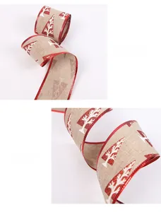 Detailed texture of burlap Christmas ribbon with red glitter edges and tree patterns