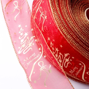 Close-up of Christmas ribbon with gold Merry Christmas print and festive tree patterns