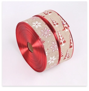 Detail view of 10m Christmas faux linen ribbon with red snowflakes and tree patterns