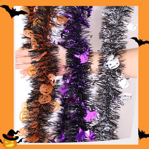 Close-up of Halloween tinsel garlands with pumpkin, bat, and skull sequins for party decor