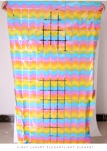 Close-up of iridescent square tinsel curtain with metallic grid patterns for party decor