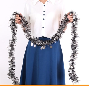 Detail of Halloween tinsel garland with black and silver fringe and skull ornaments