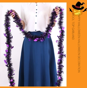 Close-up of black and purple Halloween tinsel garland with shiny bat sequins