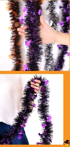 Detail of Halloween tinsel garland with metallic purple bat and orange pumpkin sequins