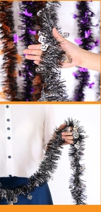 Detail of Halloween black tinsel garland with silver skull sequins for party decoration