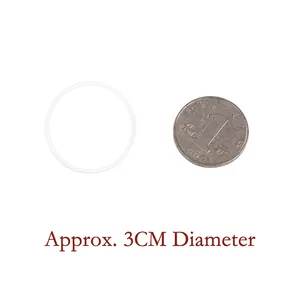 Detail view of 3cm round transparent silicone ceiling hook with a coin for scale