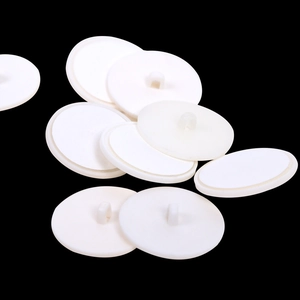 Macro shot of white circular plastic adhesive ceiling hooks with back loop hangers