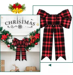Detailed view of red and black buffalo plaid Christmas bows on a decorative green wreath
