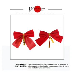 Detail view of red velvet Christmas bows with gold wire ties for tree decoration