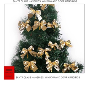 Set of 12 sparkling gold glitter bows hanging on green Christmas tree branches
