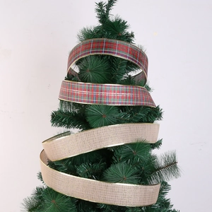 Détail de rubans de Noël à carreaux et lin avec bordures dorées sur branche de sapin