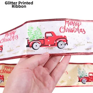 Close-up of Merry Christmas glitter ribbon with red truck and green tree pattern