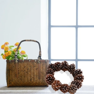 Macro detail of a natural pine cone wreath with snow spray decoration for Christmas