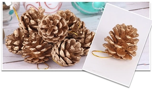 Close-up of golden pine cone ornaments with metallic finish and hanging strings