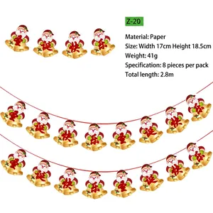 Détail de bannières de Noël en papier pailleté avec Père Noël et cloches dorées décoratives