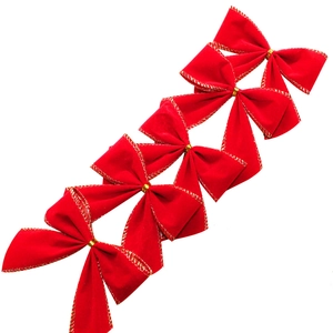 Detail of red velvet Christmas bows with gold edges and metallic center ties