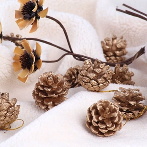 Golden natural pine cones with hanging strings for Christmas tree and home decoration